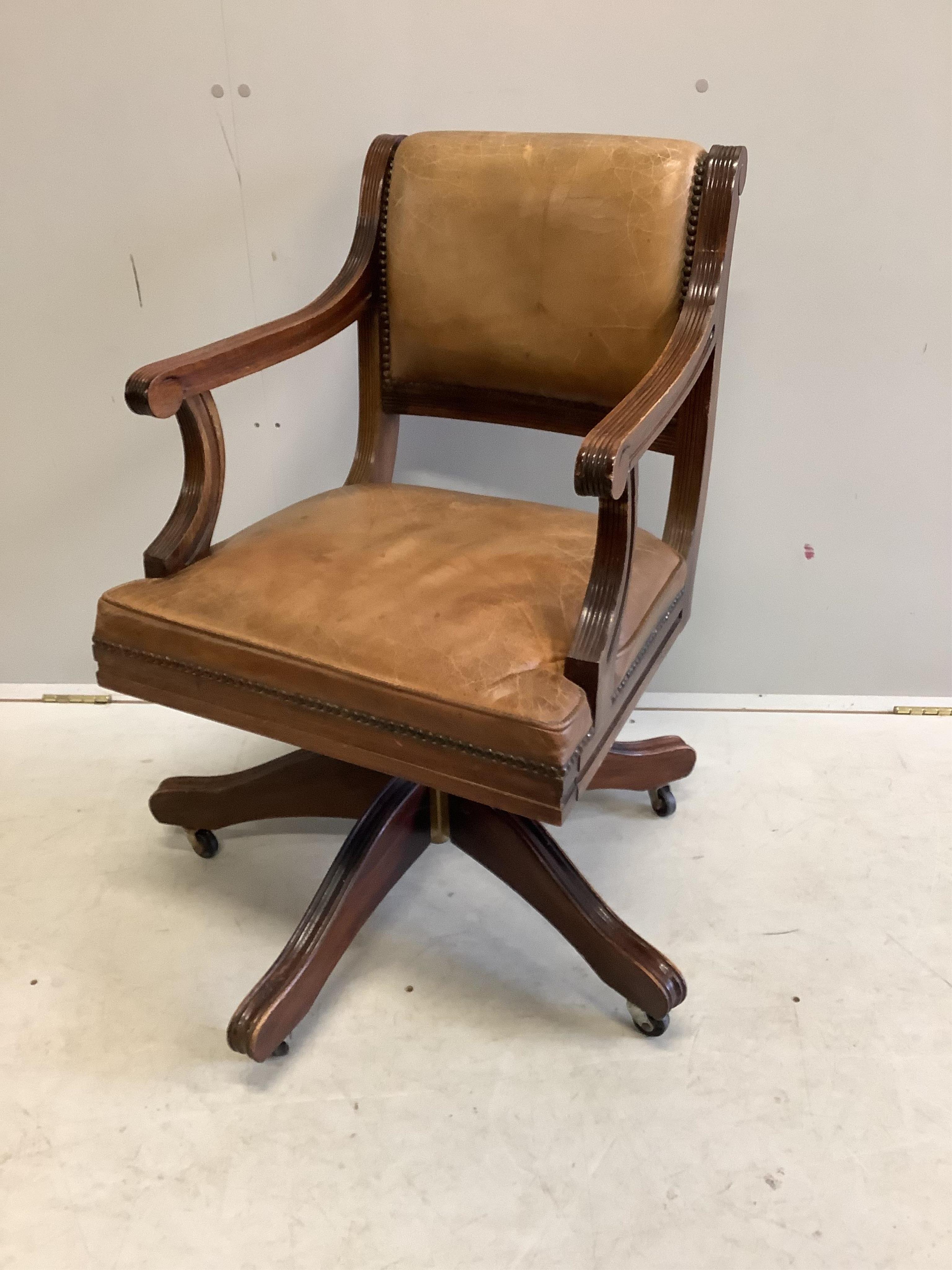 A reproduction mahogany and tan leather swivel desk chair, width 56cm, depth 52cm, height 84cm. Condition - fair